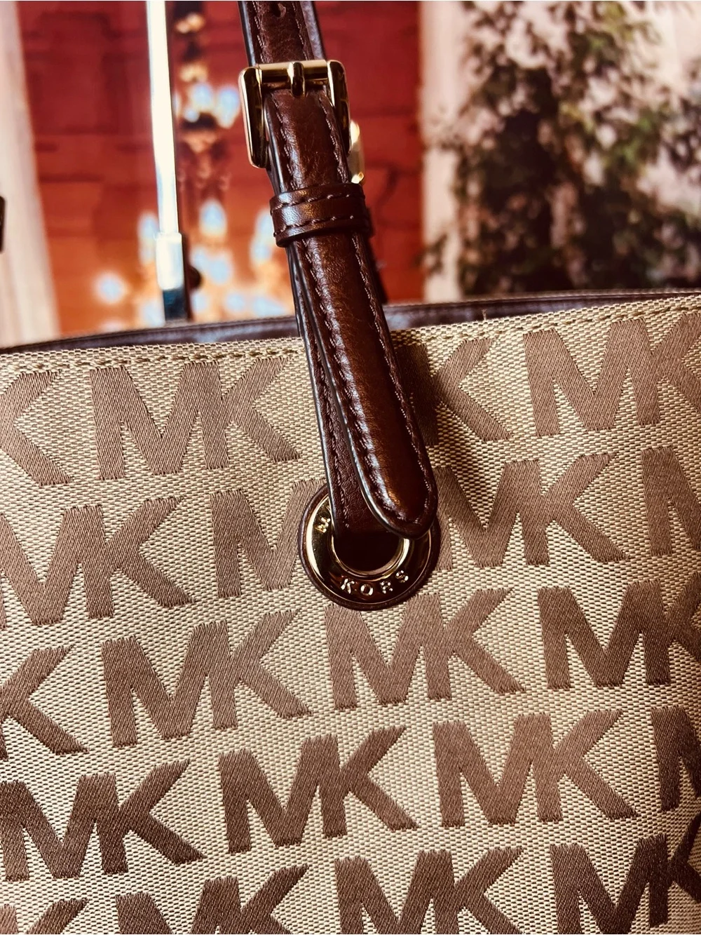 Michael Kors Jet Set tote features monogram canvas, contrasting leather straps